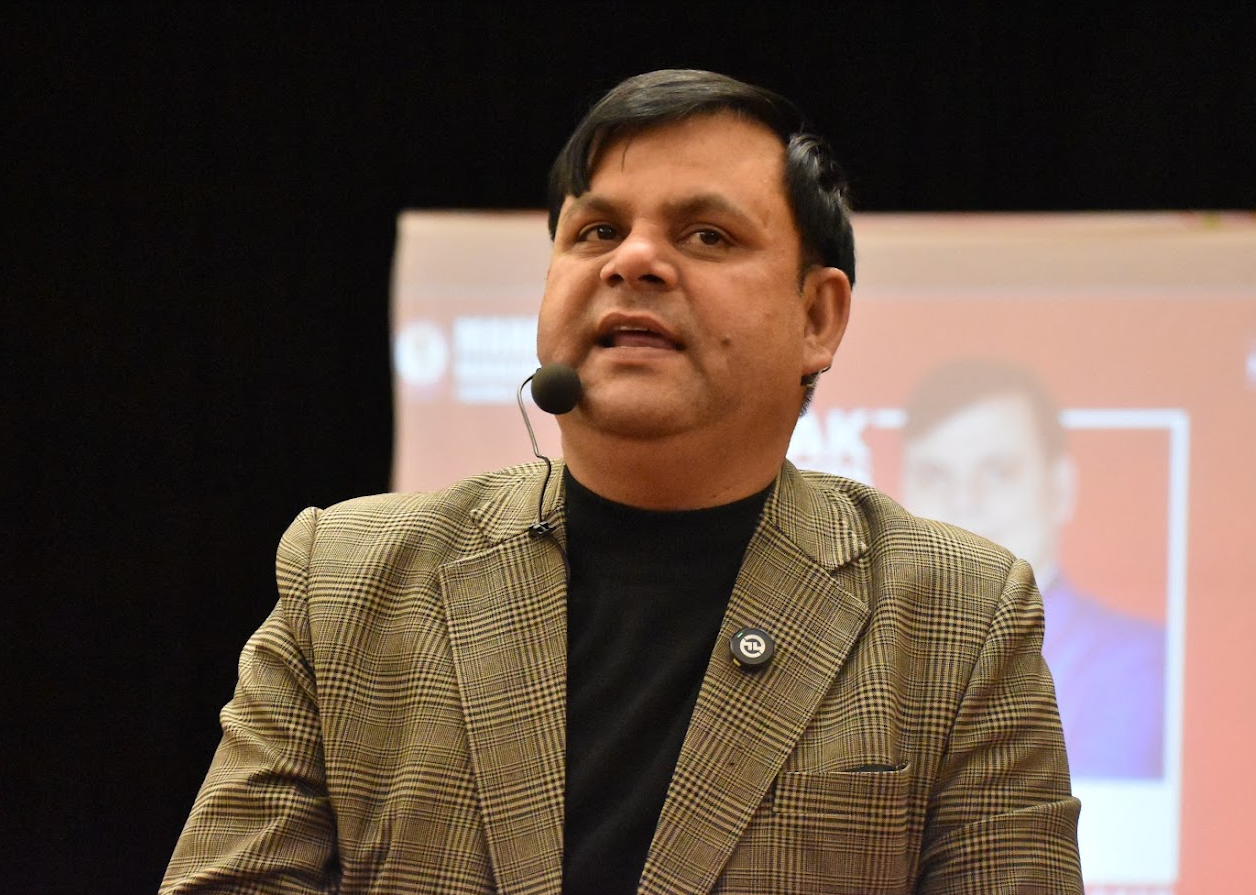 Amar Choudhary speaking on stage